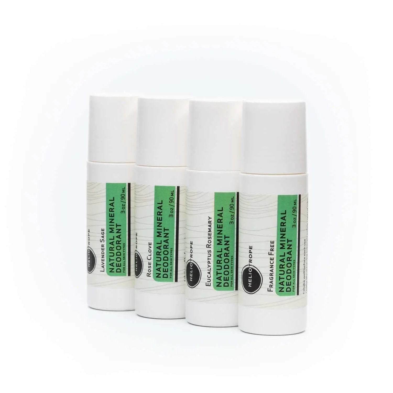 Four white roll-on Natural Mineral Deodorant sticks with green labels in different scents including fragrance-free option