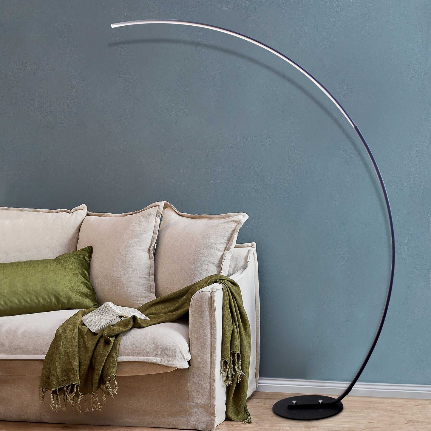 Black RGBW modern curve floor lamp with LED dimmable light and remote control next to beige sofa