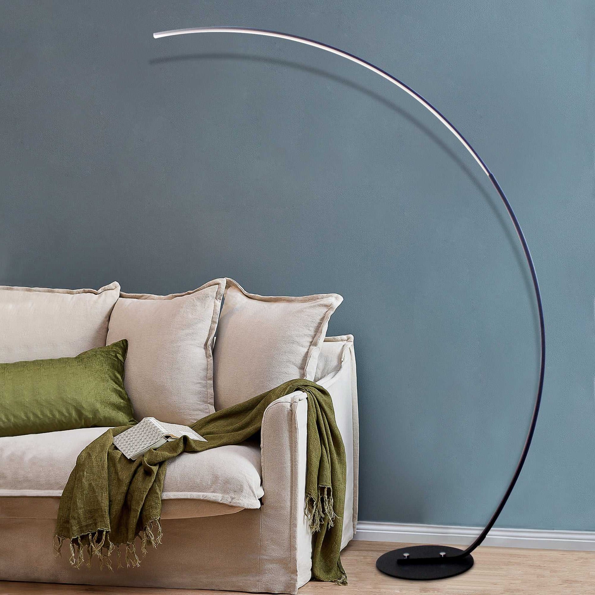 Black RGBW modern curve floor lamp with LED dimmable light and remote control next to beige sofa