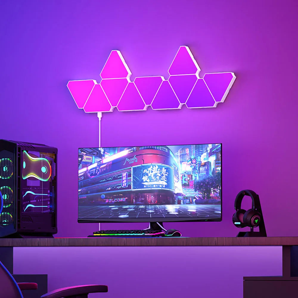 LED Triangular Quantum Lamp RGB wall light mounted above computer setup with purple illumination