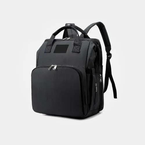 Black nylon stroller diaper bag with multiple compartments and padded shoulder straps