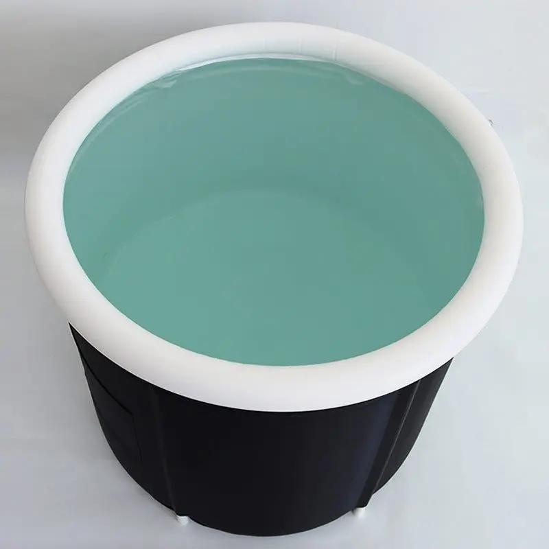 Black folding bath bucket with white rim filled with water, large capacity adult bath tub, thickened insulated design.