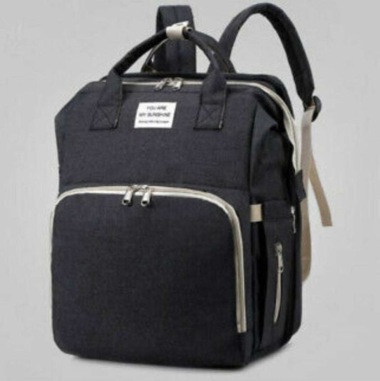 Black nylon stroller diaper bag with multiple compartments and baby bed mat included
