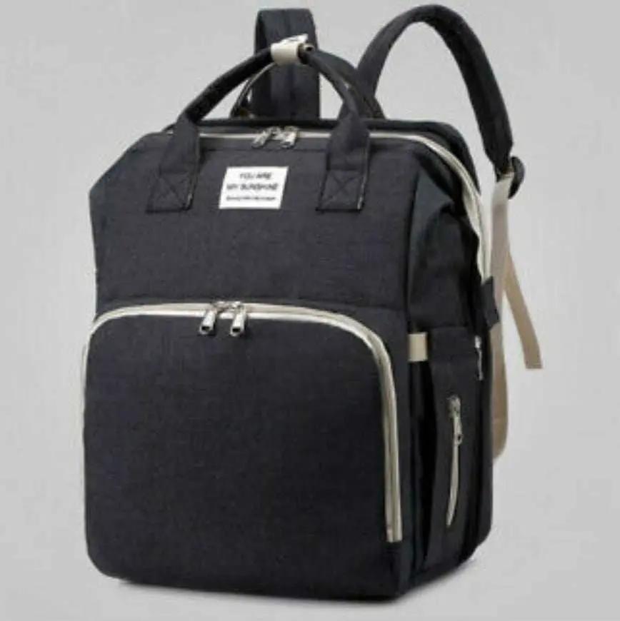 Black nylon stroller diaper bag with multiple compartments and baby bed mat included