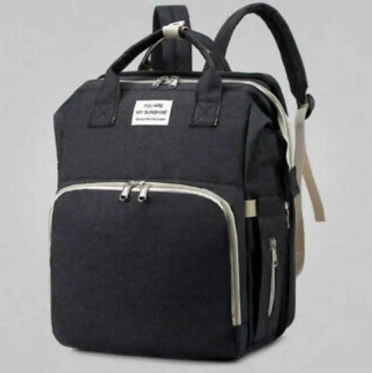 Black nylon stroller diaper bag with multiple compartments and baby bed mat included
