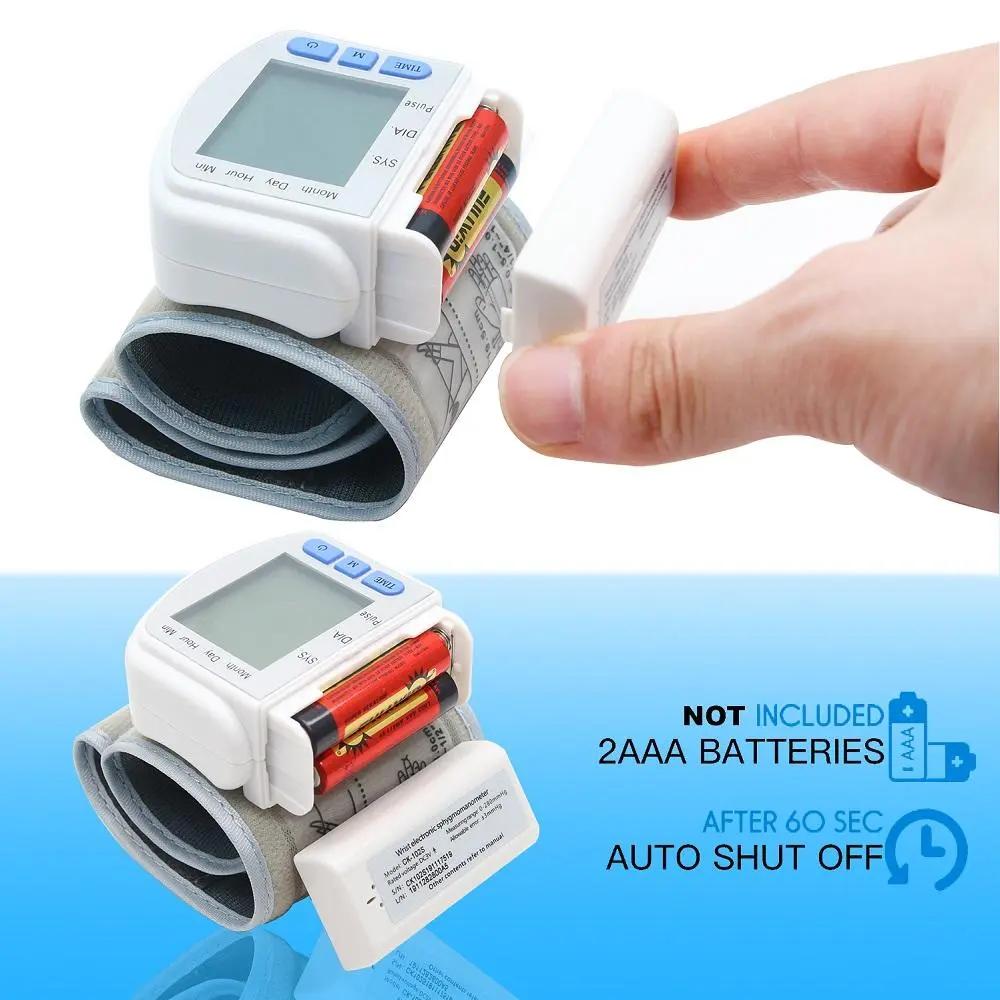 Digital wrist blood pressure monitor with LCD display, automatic memory, and battery compartment open showing AAA batteries slot