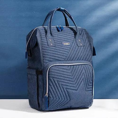 Quilted Diaper Bag Backpack in durable blue Oxford fabric with multiple pockets and padded straps for parents on the go