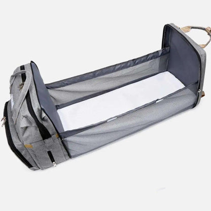 Gray nylon stroller diaper bag with expandable baby bed and travel mat