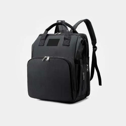 Black nylon stroller diaper bag with multiple compartments and padded shoulder straps