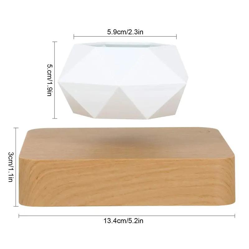 Levitating rotation flowerpot with white geometric pot floating above wooden base, magnetic bonsai planter.