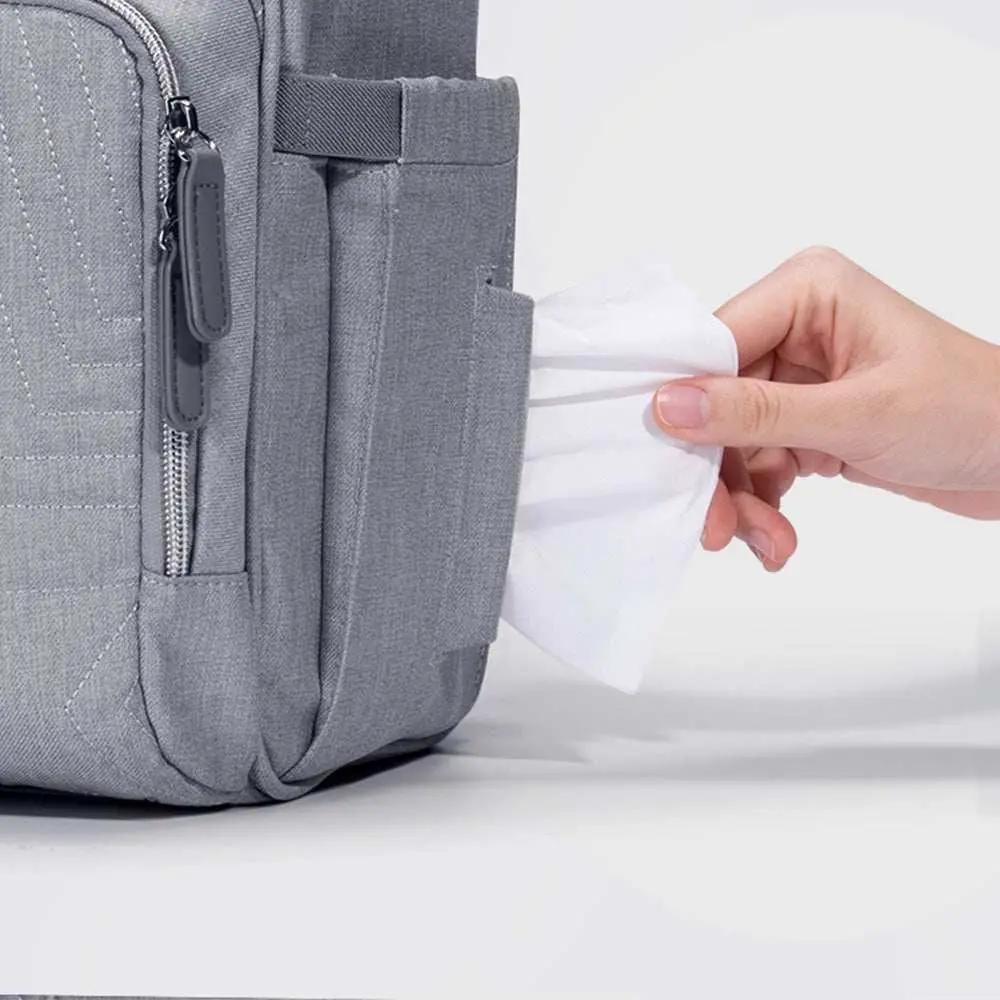Gray quilted diaper bag backpack with side pocket for wipes, made of durable Oxford fabric