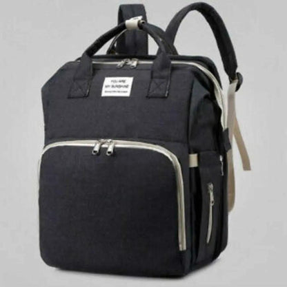 Black nylon stroller diaper bag with multiple compartments and baby bed mat included