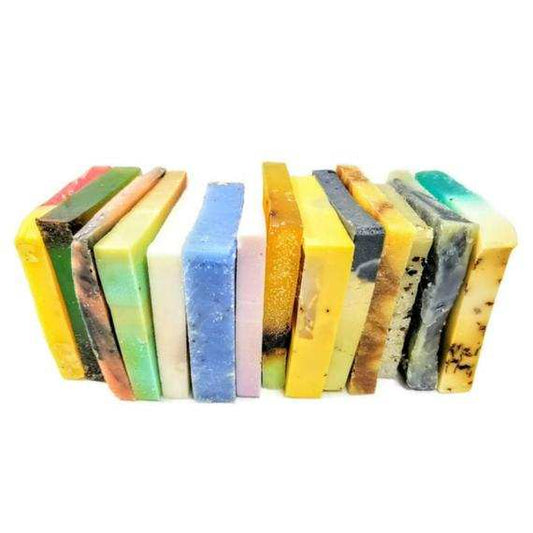 Assorted colorful vegan soap sampler bars stacked in a row with various natural ingredients
